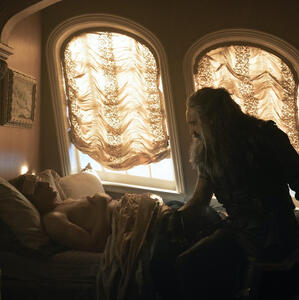 OFMD screencap: Ed sits at the foot of Stede’s bed while Stede is asleep in recovery.